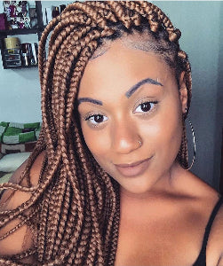 Woman wearing a braided hairstyle, braids are Color #27 Honey blonde - Elise Beauty Supply